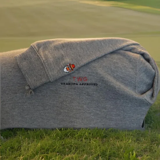 Shows the gray wise guys premium hoodie product on a golf course