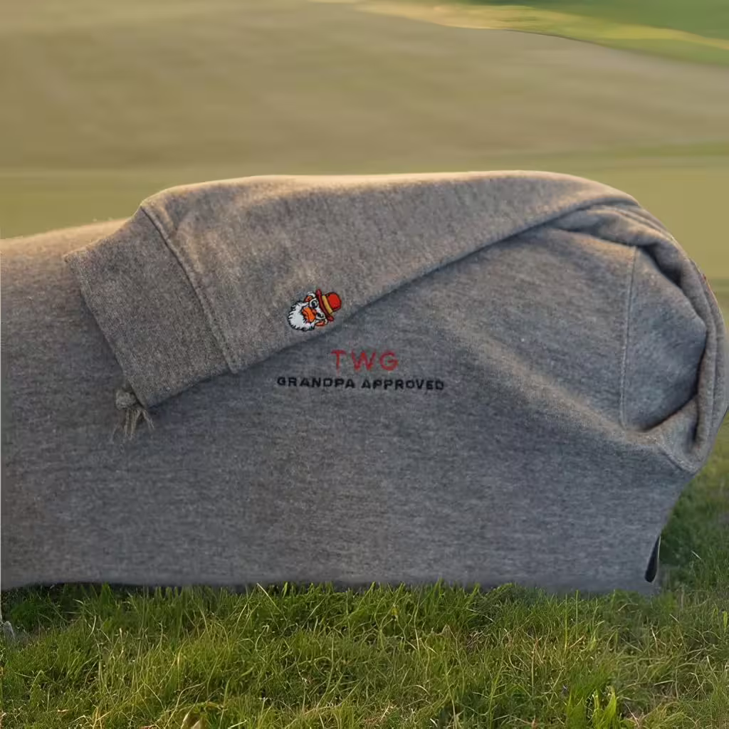 Shows the gray wise guys premium hoodie product on a golf course